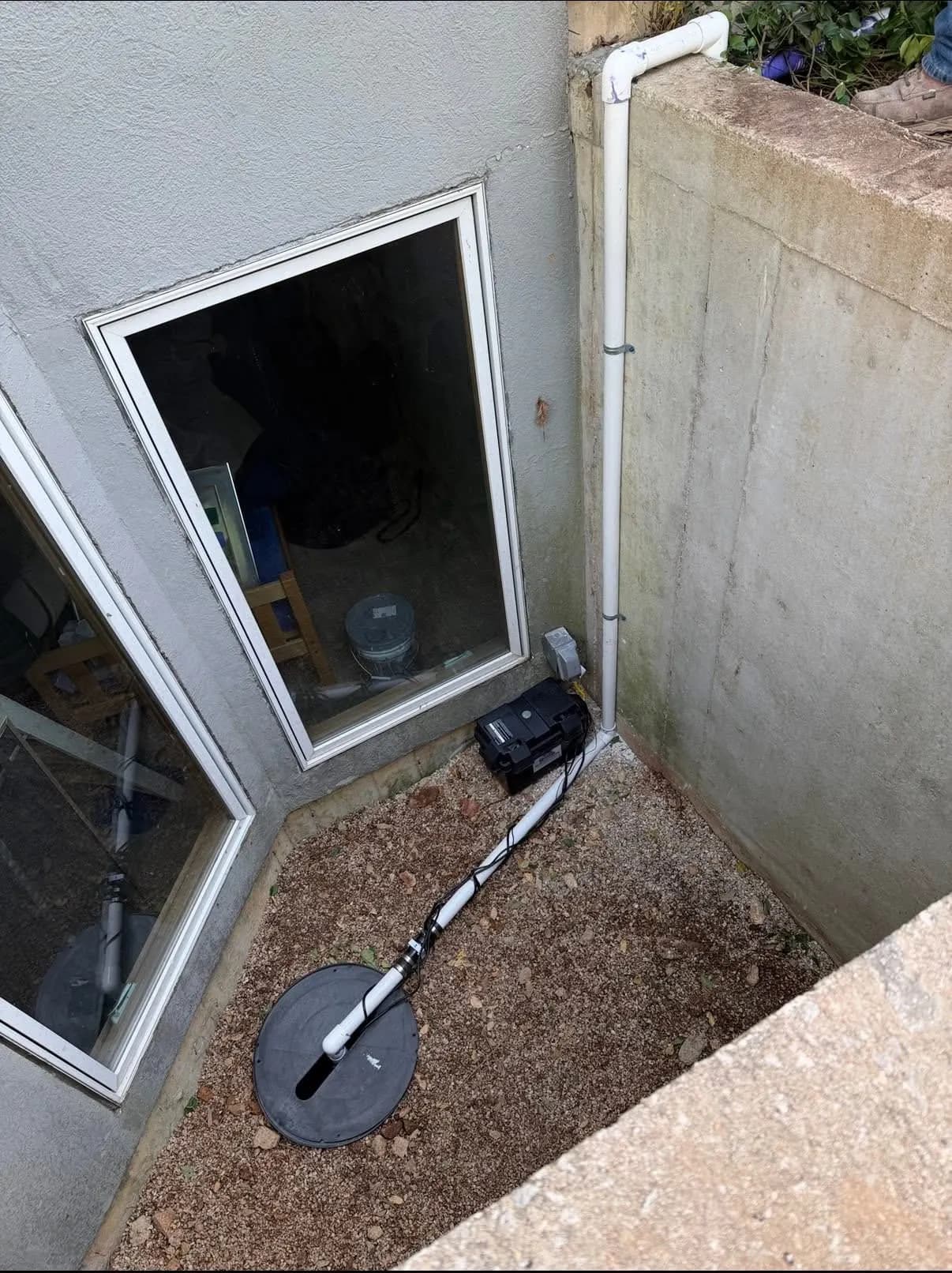 Drain line installed beside a basement window well